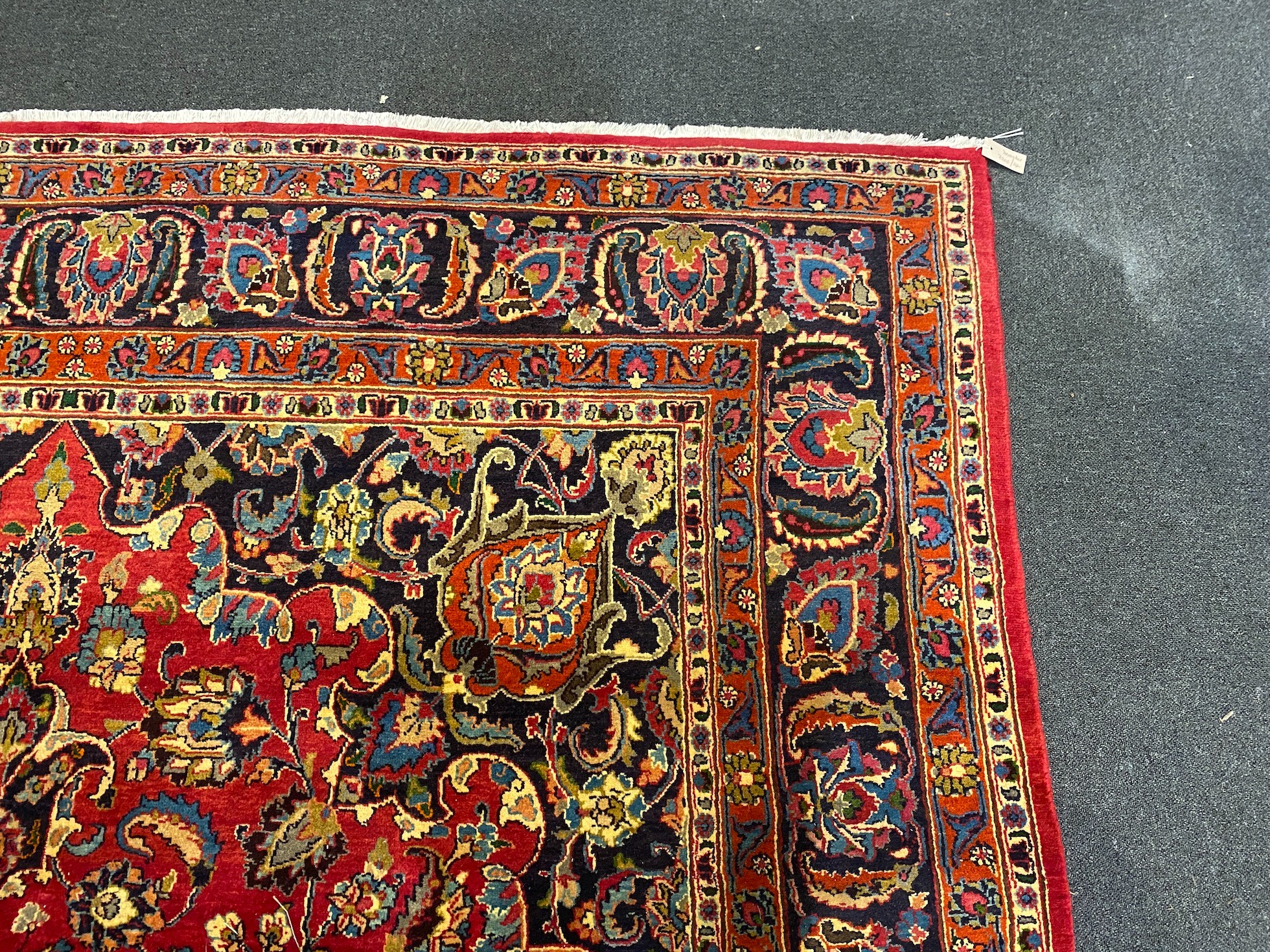 A Kashan claret ground carpet, 375cm x 250cm